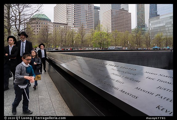 Jewish family walks by 9/11 Memorial. NYC, New York, USA (color)