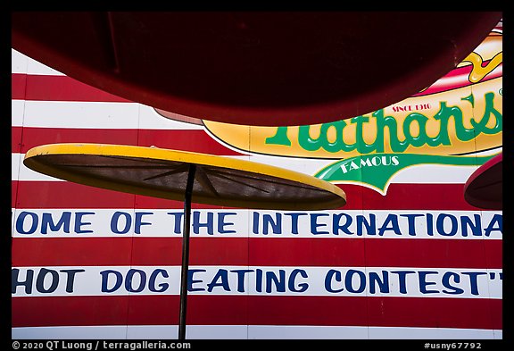 Sun umbrellas and hot dog eating contest wall. New York, USA