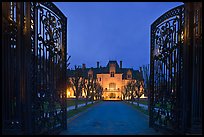 Entrance gate and historic mansion building at night. Newport, Rhode Island, USA (color)
