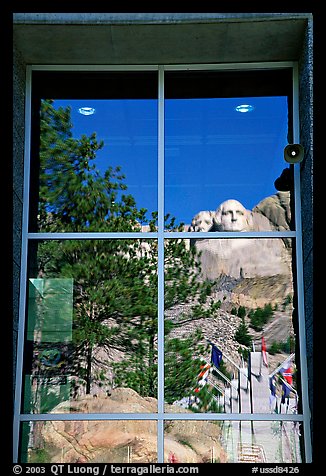 Cliff and sculptures reflected in a window, Mount Rushmore National Memorial. South Dakota, USA