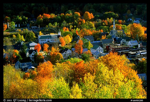 Village surounded by trees in brilliant fall colors. Vermont, New England, USA (color)