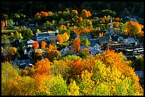 Village surounded by trees in brilliant fall colors. Vermont, New England, USA