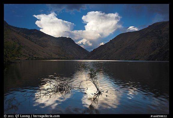 Thunderstorm clouds at sunrise reflected in reservoir. Hells Canyon National Recreation Area, Idaho and Oregon, USA (color)