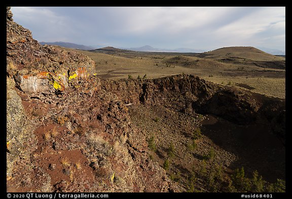 Echo crater with brightly colored rocks and Crescent Butte. Craters of the Moon National Monument and Preserve, Idaho, USA (color)