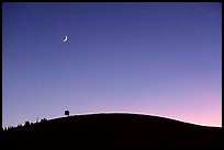 Curve of cinder cone, pastel sky, and moon. Craters of the Moon National Monument and Preserve, Idaho, USA ( color)