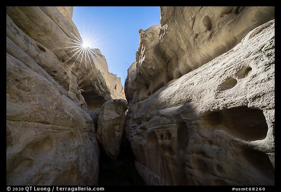 Sandstone walls of Neat Coulee slot canyon and sun. Upper Missouri River Breaks National Monument, Montana, USA