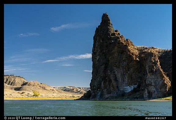 Dark igneous plug at the edge of river. Upper Missouri River Breaks National Monument, Montana, USA