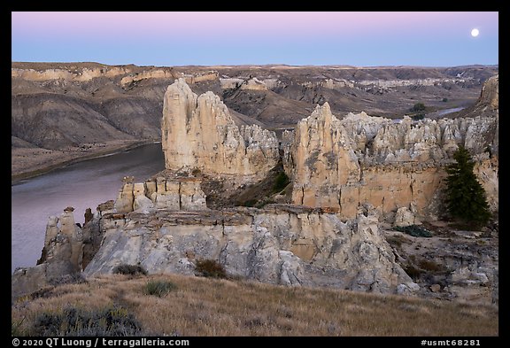 Sandstone spires and moon at twilight. Upper Missouri River Breaks National Monument, Montana, USA