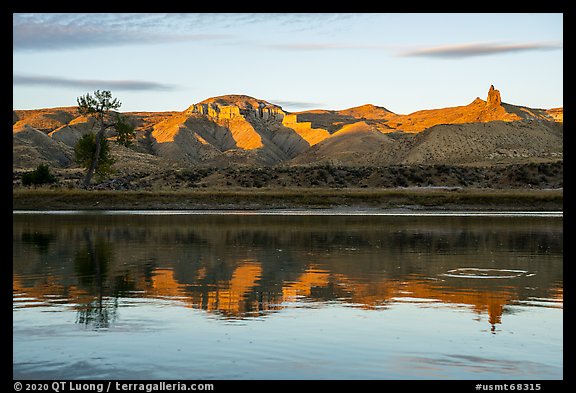 Riverbank with cliff and spires at sunset. Upper Missouri River Breaks National Monument, Montana, USA