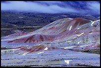 Painted hills and fog, winter dusk. John Day Fossils Bed National Monument, Oregon, USA