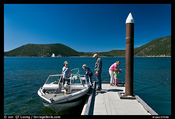 Family boarding boat, East Lake. Newberry Volcanic National Monument, Oregon, USA (color)