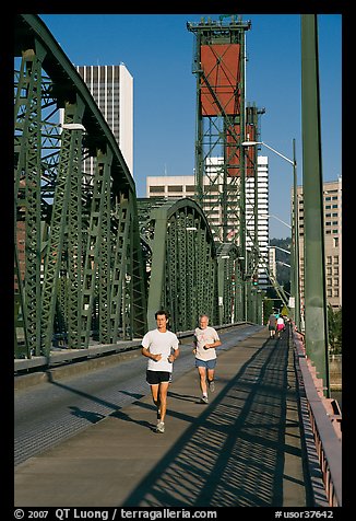 Men jogging on Hawthorne Bridge. Portland, Oregon, USA