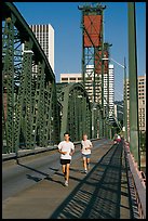 Men jogging on Hawthorne Bridge. Portland, Oregon, USA