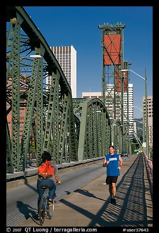 Jogger and cyclist on Hawthorne Bridge. Portland, Oregon, USA (color)
