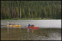 Parents kayaking with children in tow, Devils Lake. Oregon, USA ( color)
