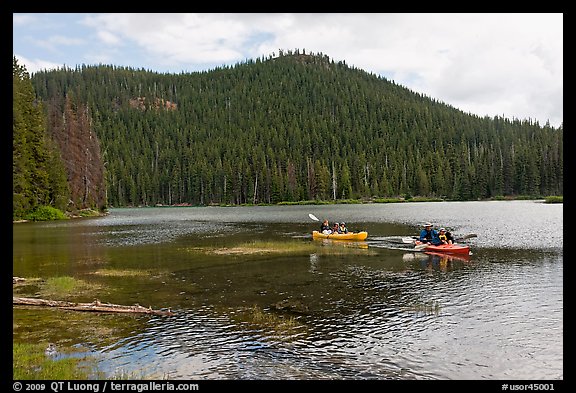 Family kayaking on Devils Lake. Oregon, USA