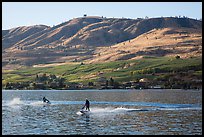 Personal watercraft riders and vineyard covered hills, Lake Chelan. Washington ( color)