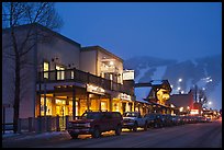 Storehouses and night-lit Snow King ski area. Jackson, Wyoming, USA (color)