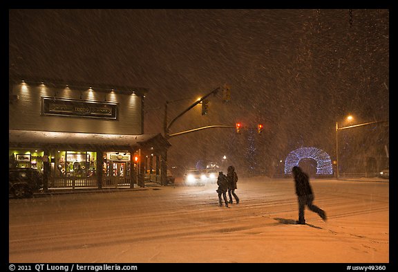 People cross street in night blizzard. Jackson, Wyoming, USA