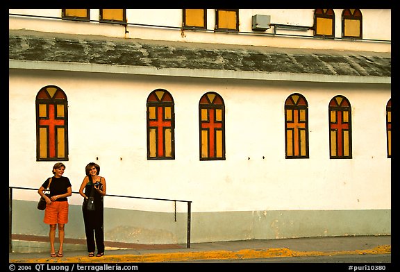 Two women standing in front of a church, La Parguera. Puerto Rico