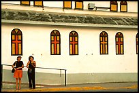 Two women standing in front of a church, La Parguera. Puerto Rico ( color)