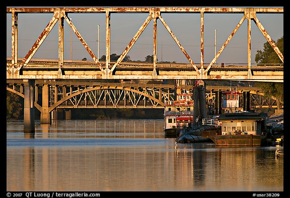 Bridges over Arkansas River, submarine and riverboats at sunrise. Little Rock, Arkansas, USA (color)