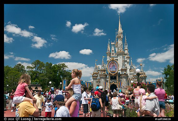 Girls on fathers shoulders, Cinderella Castle. Orlando, Florida, USA