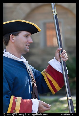 Man dressed as a Spanish soldier in the 18th century demonstrates gun, Fort Matanzas National Monument. St Augustine, Florida, USA