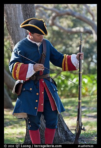 Man useing ramrod on musket, Fort Matanzas National Monument. St Augustine, Florida, USA