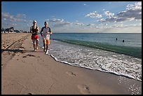 Couple jogging on beach,  Miami Beach. Florida, USA (color)