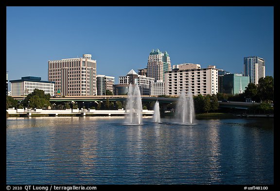 Fountains and morning skyline from Lake Lucerne. Orlando, Florida, USA (color)