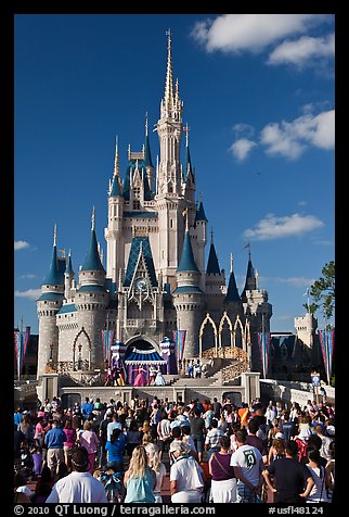 Tourists attend stage musical in front of Cindarella castle. Orlando, Florida, USA (color)