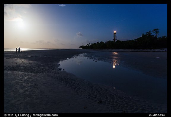 Lighthouse beach with family in distance and moonlight, Sanibel Island. Florida, USA (color)
