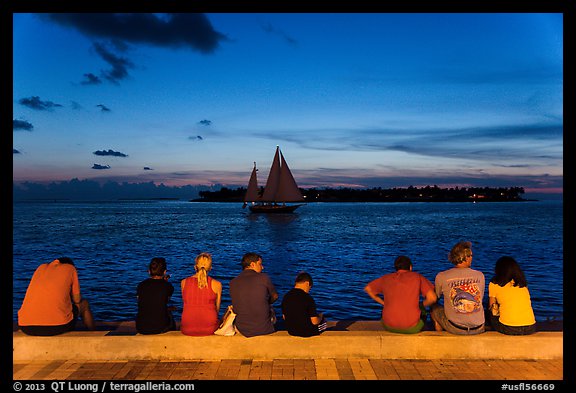 Tourists watching ocean after sunset, Mallory Square. Key West, Florida, USA