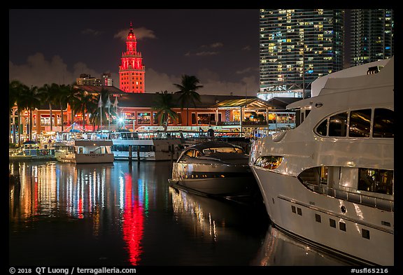 Yachts, Bayside Marketplace harbor and Freedom Tower illuminated at night, Miami. Florida, USA