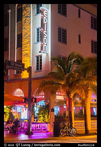 Corner street with Edison hotel, bicycle and palm tree at night, Miami Beach. Florida, USA (color)