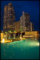 Pool surrouned by high rise towers at night, Miami. Florida, USA ( color)