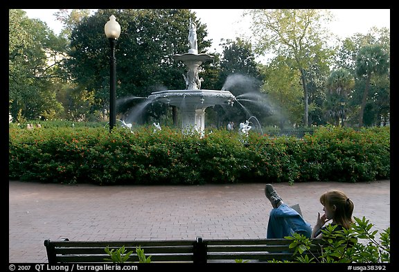 Woman reading in front of Forsyth Park Fountain. Savannah, Georgia, USA