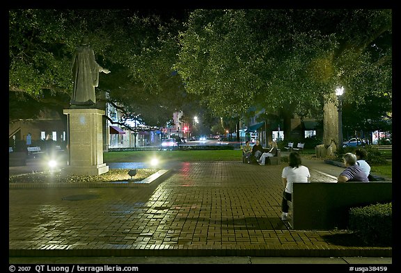 Square by night with people sitting on benches. Savannah, Georgia, USA