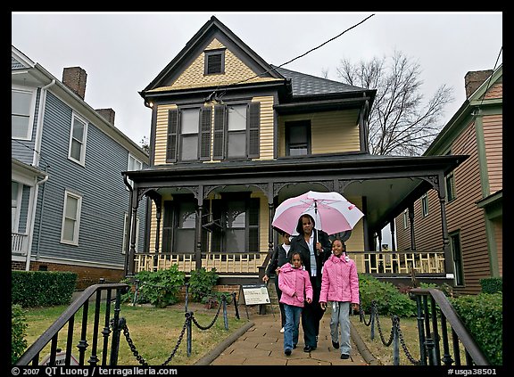 African American family with umbrella in front of Birth Home of Martin Luther King Jr. Atlanta, Georgia, USA (color)