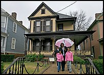 African American family with umbrella in front of Birth Home of Martin Luther King Jr. Atlanta, Georgia, USA ( color)