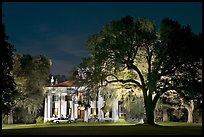 Antebellum mansion set in garden with  backlit oak tree at night. Natchez, Mississippi, USA