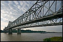 Barge on the Mississippi River approaching bridges. Natchez, Mississippi, USA