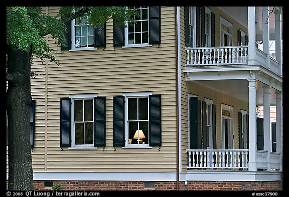House with lamp inside window. Columbia, South Carolina, USA (color)