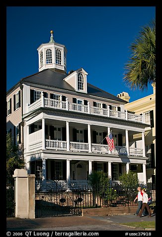 Couple walking in front of antebellum house. Charleston, South Carolina, USA (color)