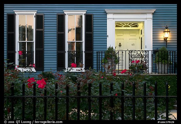 House facade at dusk with roses in front yard. Charleston, South Carolina, USA (color)