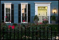 House facade at dusk with roses in front yard. Charleston, South Carolina, USA (color)