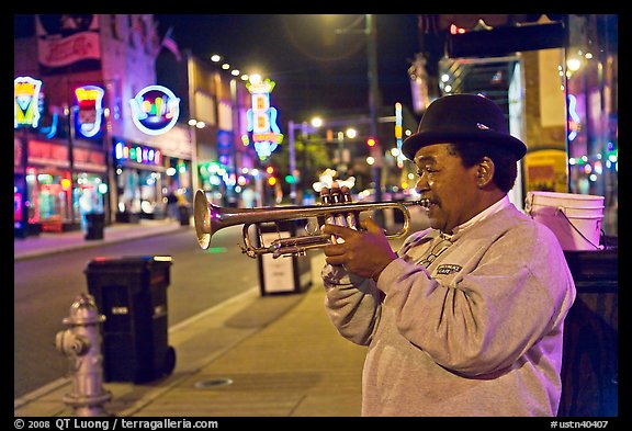 African-American man playing trumpet on Beale Street by night. Memphis, Tennessee, USA (color)