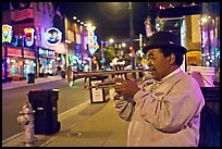 African-American man playing trumpet on Beale Street by night. Memphis, Tennessee, USA ( color)