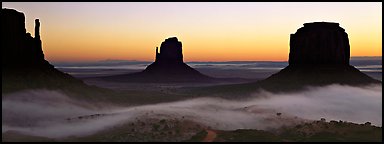 Monument Valley mittens at sunrise with fog. Monument Valley Tribal Park, Navajo Nation, Arizona and Utah, USA (Panoramic color)